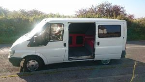 The side profile of my first campervan, a SWB white transit van. 